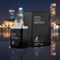Maison Alhambra Man Black Edition 100ml EDP — Black perfume bottle and box set against a blurred city night background with bokeh lights. | Maison Alhambra Man Black Edition 100ml EDP — Set botol minyak wangi hitam dan kotak berlatar belakang bandar malam yang kabur dengan lampu bokeh.
