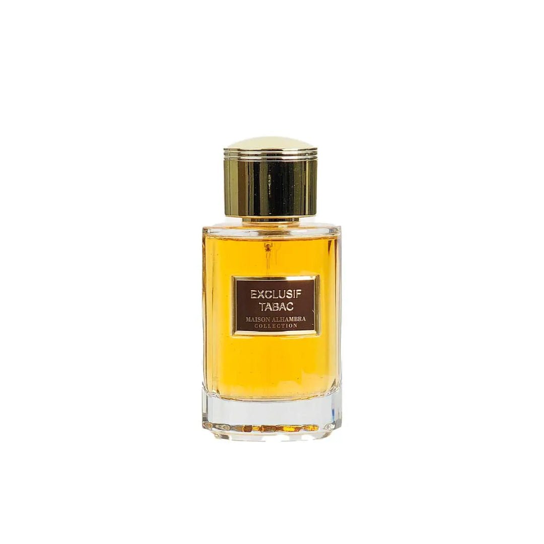 Maison Alhambra Exclusif Tabac – Amber liquid in a clear glass bottle with a gold cap, featuring a brown label with gold text. | Maison Alhambra Exclusif Tabac – Cecair berwarna ambar dalam botol kaca jernih dengan penutup emas, menampilkan label coklat dengan teks emas.