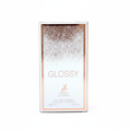 Maison Alhambra Glossy By Maison Alhambra 100ml Women EDP — A white perfume box with a rose gold glitter gradient at the top and a deer logo below. | Maison Alhambra Glossy By Maison Alhambra 100ml Women EDP — Kotak minyak wangi putih dengan gradien kilauan emas mawar di bahagian atas dan logo rusa di bawah.
