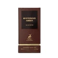Maison Alhambra Mysterious Amber — A brown box and a clear glass bottle with a gold cap, both featuring the product name and brand logo. | Maison Alhambra Mysterious Amber — Kotak coklat dan botol kaca jernih dengan penutup emas, kedua-duanya memaparkan nama produk dan logo jenama.