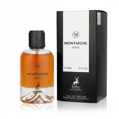 Maison Alhambra Montaigne Coco Maison Alhambra 100ml EDP — A clear glass perfume bottle with amber liquid and a black cap sits next to its black and white box, both featuring the brand's logo and product name. | Maison Alhambra Montaigne Coco Maison Alhambra 100ml EDP — Botol minyak wangi kaca jernih dengan cecair
