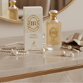 Maison Alhambra Musk Vanille by Maison Alhambra 100ml EDP — A white perfume box and bottle with gold accents sit on a marble surface, adorned with pearl necklaces and scattered pearls. | Maison Alhambra Musk Vanille by Maison Alhambra 100ml EDP — Kotak dan botol minyak wangi putih dengan perincian emas terletak di