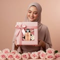 Maison Alhambra Olivia by Maison Alhambra 80ml EDP — Woman in hijab holding a pink gift box with roses and a perfume bottle inside, surrounded by pink roses | Wanita bertudung memegang kotak hadiah merah jambu berisi mawar dan botol minyak wangi, dikelilingi mawar merah jambu