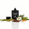 Maison Alhambra Opulence Leather — Black perfume bottle with cap beside it, surrounded by cardamom pods, jasmine flowers, bay leaves, amber resin pieces, and a small piece of brown leather. | Maison Alhambra Opulence Leather — Botol minyak wangi hitam dengan penutupnya, di kelilingi oleh buah pelaga, bunga melur, daun