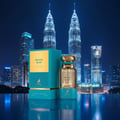 Maison Alhambra Pacific Blue by Maison Alhambra 80ml Man — A teal box and a clear glass perfume bottle with a gold cap stand in front of a nighttime cityscape with illuminated skyscrapers, including the Petronas Twin Towers. | Maison Alhambra Pacific Blue by Maison Alhambra 80ml Man — Terdapat kotak teal dan botol