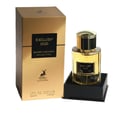 Maison Alhambra Exclusif Oud by Maison Alhambra 100 ml Unisex — A gold box with black accents sits next to a clear glass perfume bottle with a gold cap, both featuring the "Exclusif Oud" label. | Maison Alhambra Exclusif Oud by Maison Alhambra 100 ml Unisex — Kotak emas dengan aksen hitam terletak di sebelah botol