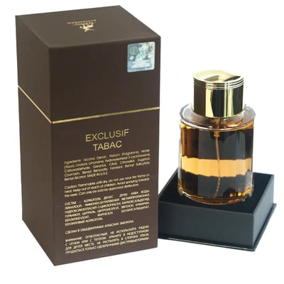 Maison Alhambra Exclusif Tabac by Maison Alhambra – 100 ml Unisex — A brown box with gold accents sits next to a clear glass perfume bottle with a gold cap, filled with amber liquid. The box has product information printed on it. | Maison Alhambra Exclusif Tabac by Maison Alhambra – 100 ml Unisex — Kotak coklat dengan
