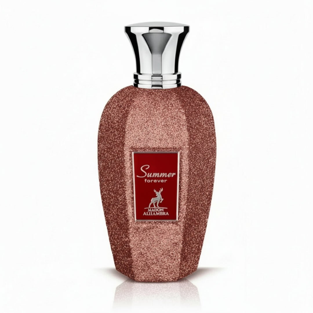 Maison Alhambra Summer Forever by Maison Alhambra 100ml EDP — A rose gold glitter-covered perfume bottle with a silver cap, featuring a red label with gold text and a deer silhouette. | Maison Alhambra Summer Forever by Maison Alhambra 100ml EDP — Botol minyak wangi berwarna emas mawar berkilauan dengan penutup perak