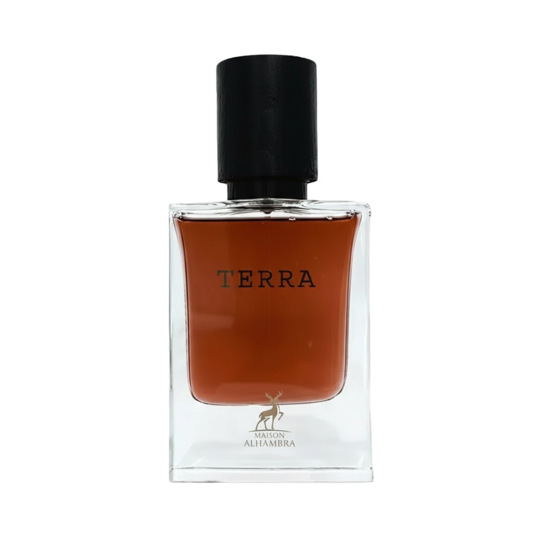 Maison Alhambra Terra – A clear glass bottle with a dark amber liquid, a black cap, and the word "TERRA" printed in black on the front. A small gold deer logo is visible at the bottom. | Maison Alhambra Terra – Botol kaca jernih dengan cecair berwarna ambar gelap, penutup hitam, dan perkataan "TERRA" dicetak hitam di