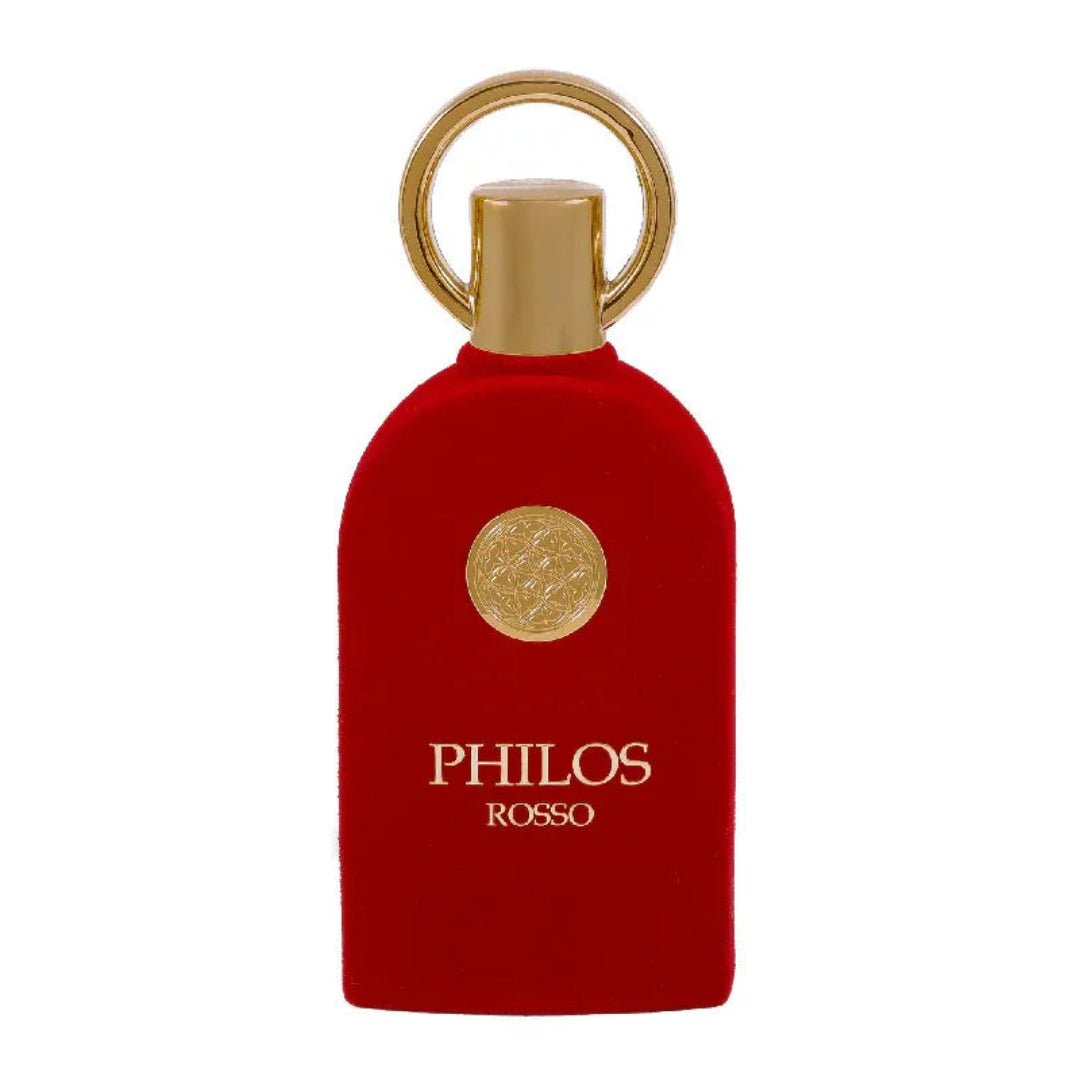 Maison Alhambra Philos Rosso Maison Alhambra 100ml EDP — A red velvet perfume bottle with a gold circular emblem and a gold ring on top, against a white background. | Maison Alhambra Philos Rosso Maison Alhambra 100ml EDP — Botol minyak wangi baldu merah dengan lambang bulat emas dan cincin emas di atas, berlatar