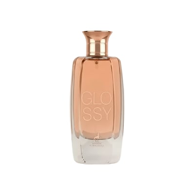 Maison Alhambra Glossy By Maison Alhambra 100ml Women EDP — A clear glass perfume bottle with a rose gold cap and a peach-colored liquid inside, featuring the word "GLOSSY" embossed vertically on the front. | Maison Alhambra Glossy By Maison Alhambra 100ml Women EDP — Botol minyak wangi kaca jernih dengan penutup emas