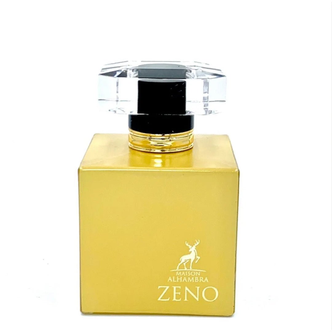 Maison Alhambra Zeno — A golden square perfume bottle with a clear faceted cap and gold accents, featuring a deer silhouette and brand name | Maison Alhambra Zeno — Botol minyak wangi persegi keemasan dengan penutup faset jernih dan aksen emas, menampilkan siluet rusa dan nama jenama