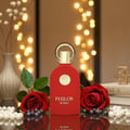 Maison Alhambra Philos Rosso Maison Alhambra 100ml EDP — A red perfume bottle with a gold cap and emblem, flanked by two red roses and a strand of pearls, with bokeh lights in the background. | Botol minyak wangi merah dengan penutup dan lambang emas, diapit oleh dua mawar merah dan seutas mutiara, dengan lampu bokeh