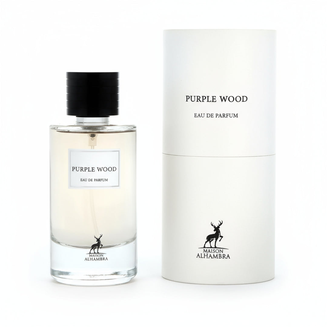 Maison Alhambra Purple Wood — A clear glass perfume bottle with a black cap and a white label reading "PURPLE WOOD EAU DE PARFUM" sits next to its matching white cylindrical box, both featuring a deer logo. | Maison Alhambra Purple Wood — Botol kaca jernih dengan penutup hitam dan label putih bertuliskan "PURPLE WOOD