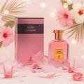 Maison Alhambra Rose Origami — A pink perfume bottle and its box are displayed with pink origami cranes and feathers on a soft pink background with bokeh lights and hibiscus flowers. | Maison Alhambra Rose Origami — Sebotol minyak wangi merah jambu dan kotaknya dipamerkan bersama bangau origami merah jambu dan bulu