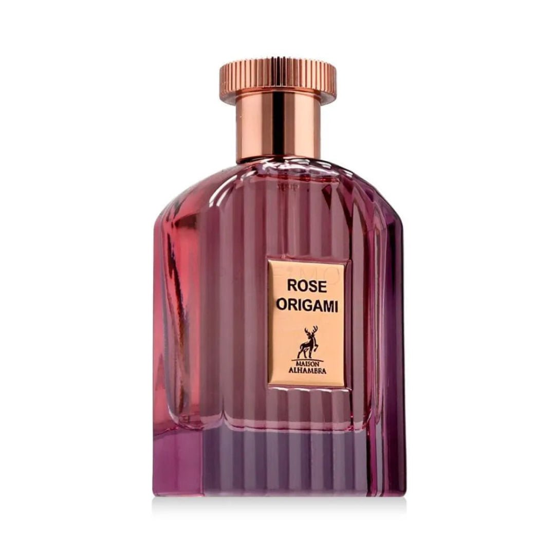 Maison Alhambra Rose Origami by Maison Alhambra 100ml — A clear glass perfume bottle with pink and purple gradient liquid, featuring a gold label with text and a deer silhouette, topped with a rose gold cap. | Maison Alhambra Rose Origami by Maison Alhambra 100ml — Botol minyak wangi kaca jernih dengan cecair gradien