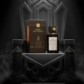 Maison Alhambra Smoked Oud & Vanilla — A dark glass perfume bottle and its matching box sit on a dark, ornate throne-like structure with smoke effects | Maison Alhambra Smoked Oud & Vanilla — Botol minyak wangi kaca gelap dan kotaknya yang sepadan duduk di atas struktur gelap seperti takhta berhias dengan kesan asap