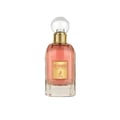 Maison Alhambra So Candid — A clear glass perfume bottle with pink liquid, a gold label featuring a deer, and a clear spherical cap, set against a white background. | Maison Alhambra So Candid — Botol minyak wangi kaca jernih dengan cecair merah jambu, label emas menampilkan rusa, dan penutup sfera jernih, berlatarkan