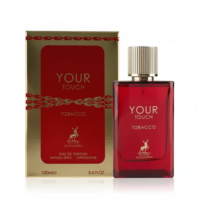 Maison Alhambra Tobacco Your Touch – Red glass perfume bottle and matching gold and red box with deer logo, on a white reflective surface | Maison Alhambra Tobacco Your Touch – Botol minyak wangi kaca merah dan kotak emas dan merah yang sepadan dengan logo rusa, di atas permukaan putih yang memantul