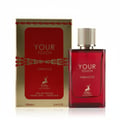 Maison Alhambra Tobacco Your Touch – Red glass perfume bottle and matching gold and red box with deer logo, on a white reflective surface | Maison Alhambra Tobacco Your Touch – Botol minyak wangi kaca merah dan kotak emas dan merah yang sepadan dengan logo rusa, di atas permukaan putih yang memantul