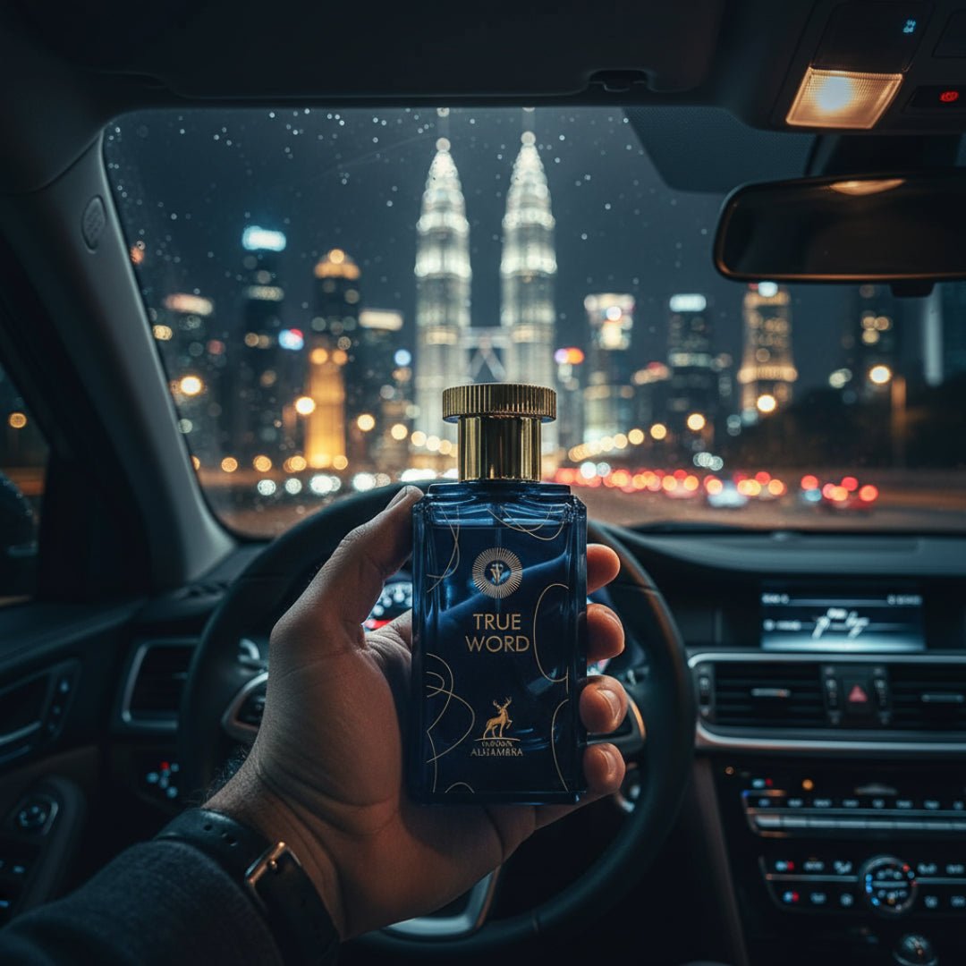 Maison Alhambra True Word by Maison Alhambra 100ml EDP — A hand holds a blue glass perfume bottle with a gold cap inside a car at night, with city skyscrapers and lights in the background. | Maison Alhambra True Word by Maison Alhambra 100ml EDP — Tangan memegang botol minyak wangi kaca biru dengan penutup emas di
