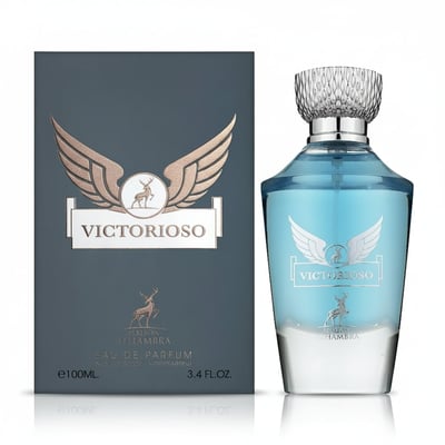 Maison Alhambra Victorioso by Maison Alhambra 100ml EDP Men — A dark grey box with gold wings and a deer logo stands next to a clear glass perfume bottle with blue liquid and a silver cap, featuring matching gold wings and deer logo. | Maison Alhambra Victorioso by Maison Alhambra 100ml EDP Men — Kotak kelabu gelap