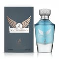 Maison Alhambra Victorioso by Maison Alhambra 100ml EDP Men — A dark grey box with gold wings and a deer logo stands next to a clear glass perfume bottle with blue liquid and a silver cap, featuring matching gold wings and deer logo. | Maison Alhambra Victorioso by Maison Alhambra 100ml EDP Men — Kotak kelabu gelap