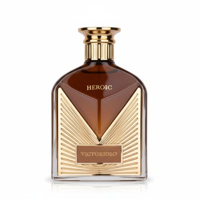 Maison Alhambra Victorioso Heroic — A brown glass perfume bottle with gold accents and the word HEROIC embossed on the front, set against a white background. | Botol minyak wangi kaca perang Maison Alhambra Victorioso Heroic dengan perincian emas dan perkataan HEROIC tertera di hadapan, berlatarkan putih.