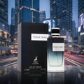 Maison Alhambra Yeah by Maison Alhambra 100ml EDP Men — A perfume bottle and its box are displayed in front of a blurred cityscape at night with light trails from cars. | Maison Alhambra Yeah by Maison Alhambra 100ml EDP Men — Botol minyak wangi dan kotaknya dipamerkan di hadapan latar bandar yang kabur pada waktu