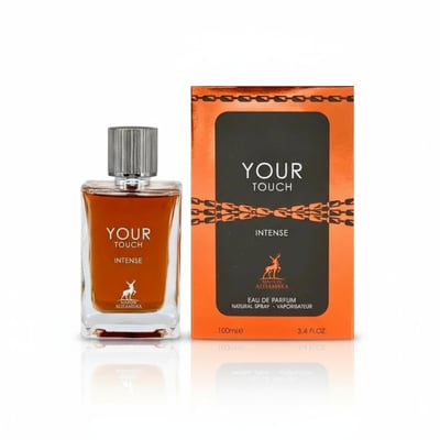 Maison Alhambra Your Touch Intense by Maison Alhambra 100ml — A clear glass perfume bottle with amber liquid and a silver ribbed cap sits next to its orange and black box with chain-link design. | Maison Alhambra Your Touch Intense by Maison Alhambra 100ml — Botol kaca jernih dengan cecair ambar dan penutup bergaris