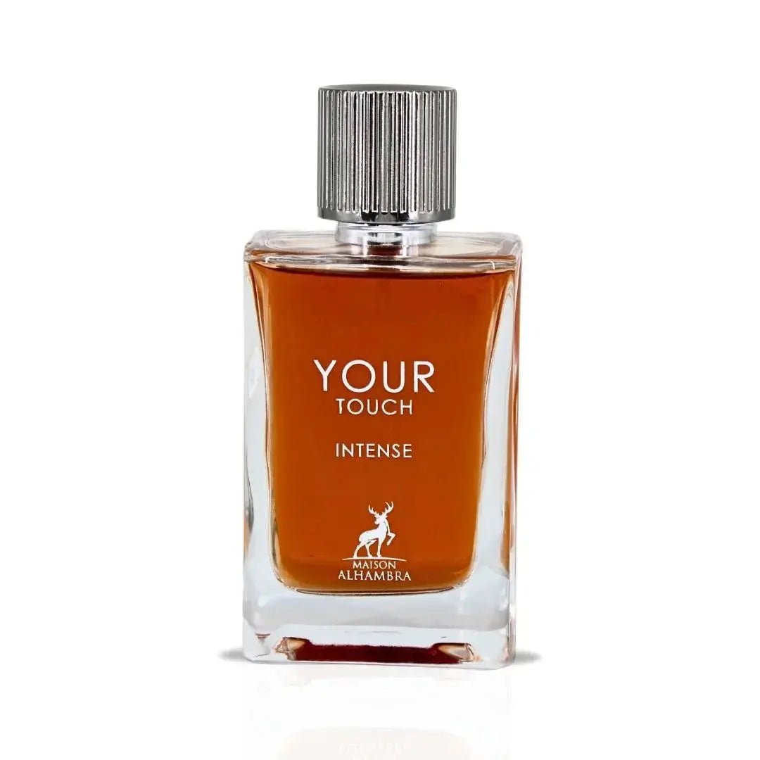 Maison Alhambra Your Touch Intense — A clear glass perfume bottle with amber liquid and a silver ribbed cap, featuring white text 'YOUR TOUCH INTENSE' and a deer logo | Maison Alhambra Your Touch Intense — Botol kaca jernih dengan cecair ambar dan penutup berjalur perak, menampilkan teks putih 'YOUR TOUCH INTENSE' dan