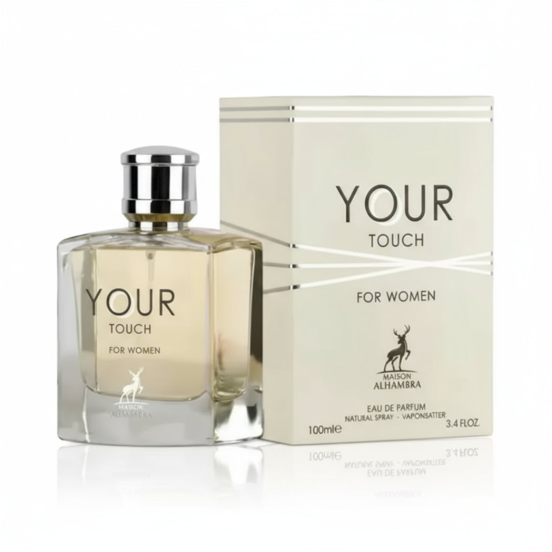 Maison Alhambra Your Touch Women by Maison Alhambra – 100 ml — A clear glass perfume bottle with a silver cap sits next to its cream-colored box, both featuring the "YOUR TOUCH" branding and a deer logo. | Maison Alhambra Your Touch Women by Maison Alhambra – 100 ml — Botol minyak wangi kaca jernih bertutup perak