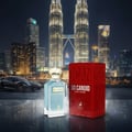 Maison Alhambra Candid Pour Homme — A black sports car and a bottle of Candid Pour Homme perfume are displayed in front of the Petronas Twin Towers at night, with a red product box to the right. | Maison Alhambra Candid Pour Homme — Kereta sport hitam dan sebotol minyak wangi Candid Pour Homme dipamerkan di hadapan